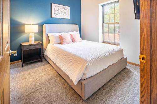 a bedroom with a bed with a nightstand and a window at Landing Stunning 1BD Courtyard in Leavenworth