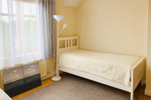 a small bedroom with a bed and a window at Slavia in Castleknock