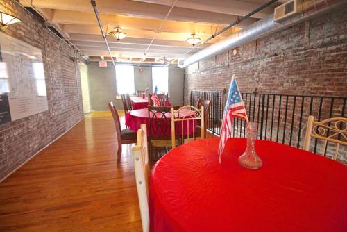 a room with a red table with a flag on it at Landing Stunning 1BD Courtyard in Leavenworth