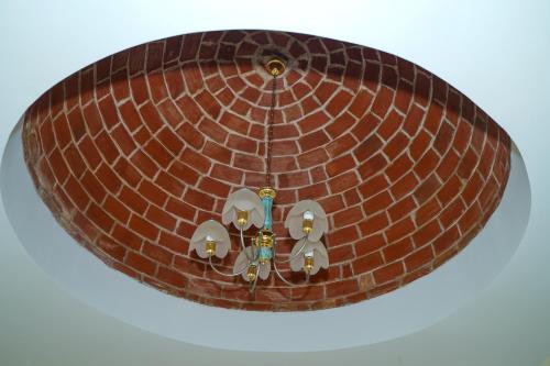 a brick ceiling with a chandelier at Les villas Africa Jade in Korba