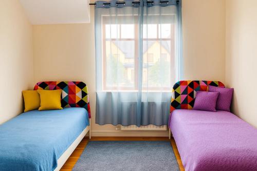 two beds in a room with a window at Slavia in Castleknock
