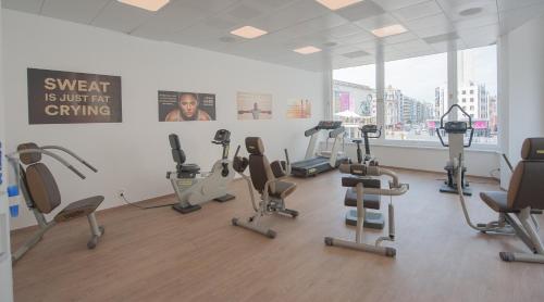 a gym with treadmills and exercise bikes in a room at C-Hotels Andromeda in Ostend
