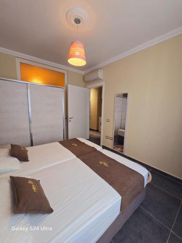 a hotel room with two beds and a light at Nova Apartaments Qerret in Golem