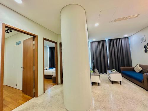 a living room with a surfboard in the middle of a room at Sky Suites Luxury Home KLCC in Kuala Lumpur