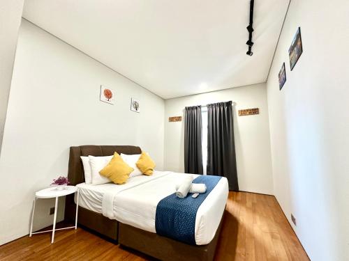 a bedroom with a large bed with yellow pillows at Sky Suites Luxury Home KLCC in Kuala Lumpur