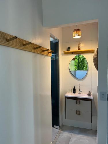 a bathroom with a sink and a mirror at Suítes Preguiça in Sao Jorge