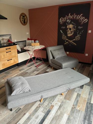 a bed and a chair in a room at Le Hangar - Studio esprit industriel in Pont-Rémy