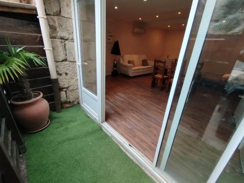 a sliding glass door leading to a living room at Studio A côté Du Plus Beau Marché De France in Béziers