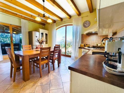 a kitchen with a table and chairs and a dining room at Villa Dol an ideal spa and wellness escape in Istria in Buzet
