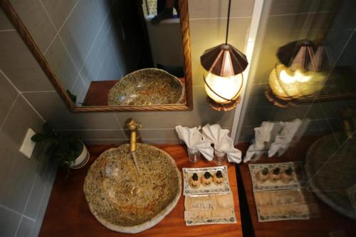 a bathroom with a sink and a mirror at Tam Coc Lion Kings Hotel & Resort Ninh Binh in Ninh Binh