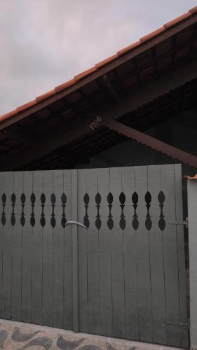 a gray garage door with a metal fence at Mongaguá, AGENOR de Campos, PRAIA in Mongaguá