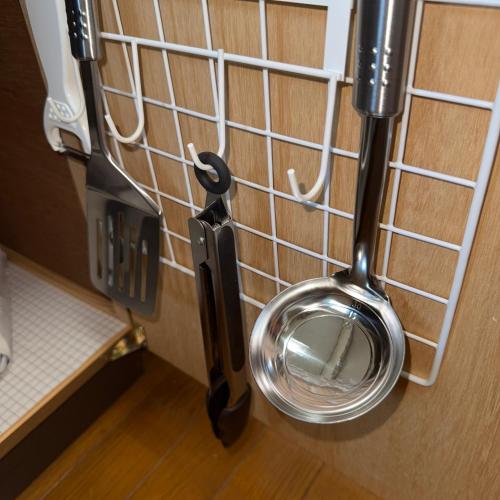 a metal toilet hanging on a wall at 折尾Inホテル305 in Kitakyushu