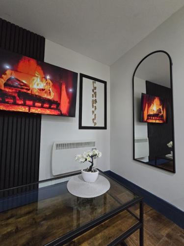 a living room with a table and a mirror at The Nook Free Parking Short way City Centre in Hull