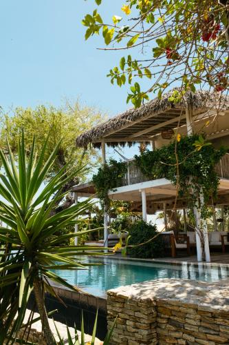a swimming pool in front of a house at Villa Praia - La Villa Group in Jericoacoara