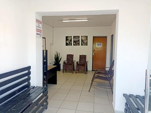a hallway with chairs and a table in a building at Hostel JK in Bom Jesus