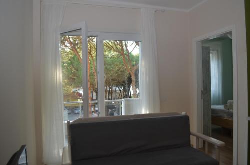 a living room with a window and a couch and a view at Rezidenca Kalter Durres in Golem