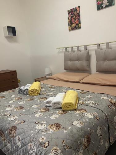 a bedroom with two beds with towels on the bed at Tower casa vacanze in Anzio
