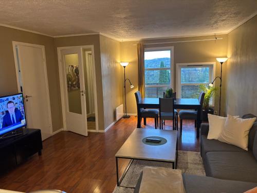 a living room with a couch and a table at JECI Apartment Sandvika Bærum - Great view and Attractive in Østre Jong