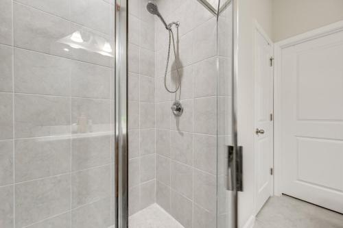 a shower with a glass door in a bathroom at Abi home in Brandon