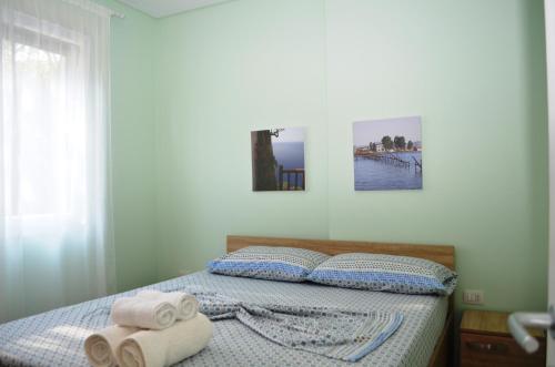 a bedroom with a bed with towels on it at Rezidenca Kalter Durres in Golem