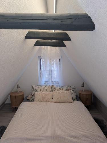 a bedroom with a large bed in a attic at Ferienwohnung Ella in Dinkelsbühl