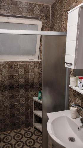 a bathroom with a sink and a mirror at White Night in Skopje