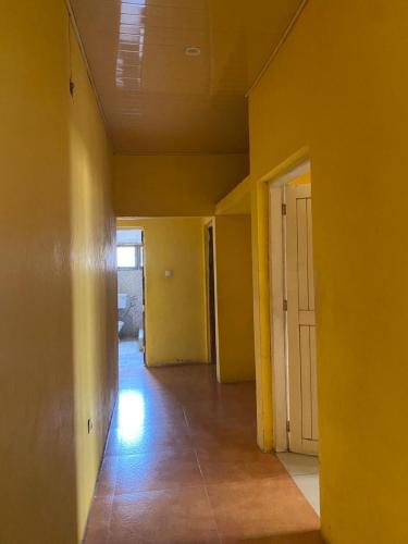 an empty room with yellow walls and a door at Samuge Village in Namacurra