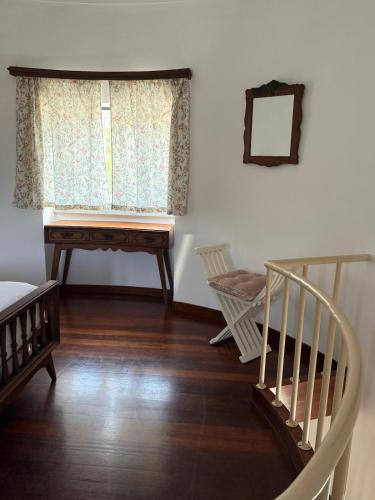 a room with a staircase and a desk and a window at Moinho da Saudade in Alcabideche