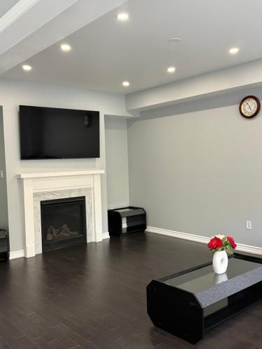 a living room with a fireplace and a flat screen tv at one bet room in Whitby