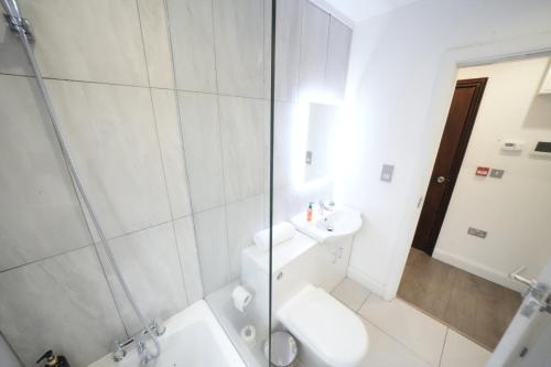 a bathroom with a shower and a toilet and a sink at Hatton apartments HEATHROW AIRPORT- FREE parking-Free underground to and from Heathrow Airport Hatton Cross SEE picture-SEE LONDON fast Hatton cross to central London 30min in London