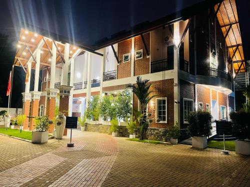 a building with a courtyard with plants in front of it at Even Beach Oasis in Waikkal