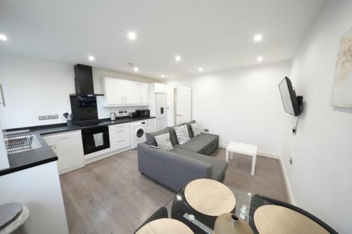 a living room with a couch and a kitchen at Hatton apartments HEATHROW AIRPORT- FREE parking-Free underground to and from Heathrow Airport Hatton Cross SEE picture-SEE LONDON fast Hatton cross to central London 30min in London