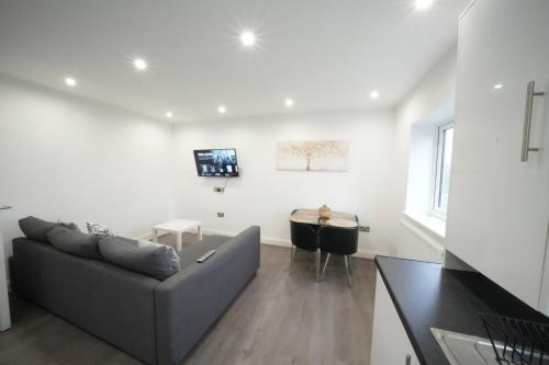 a living room with a couch and a table at Hatton apartments HEATHROW AIRPORT- FREE parking-Free underground to and from Heathrow Airport Hatton Cross SEE picture-SEE LONDON fast Hatton cross to central London 30min in London