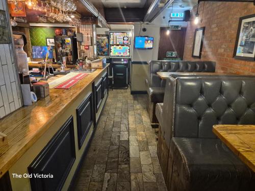 a bar with leather seats in a restaurant at The Old Victoria in Penrith