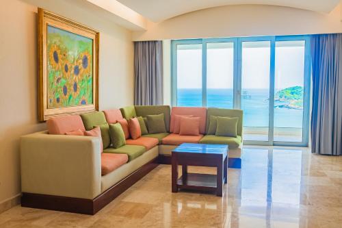 a living room with a couch and a table at Azul Ixtapa Grand All Inclusive Suites - Spa & Convention Center in Ixtapa
