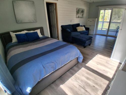 a bedroom with a bed and a couch and a chair at Country Hideaway For A True Getaway- Construction special rate in Montgomery