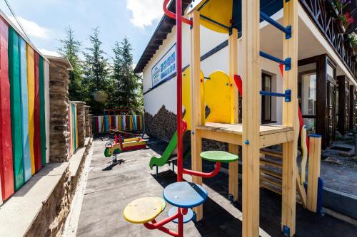a playground with a slide and play equipment at Alpiyskiy in Yablunytsya