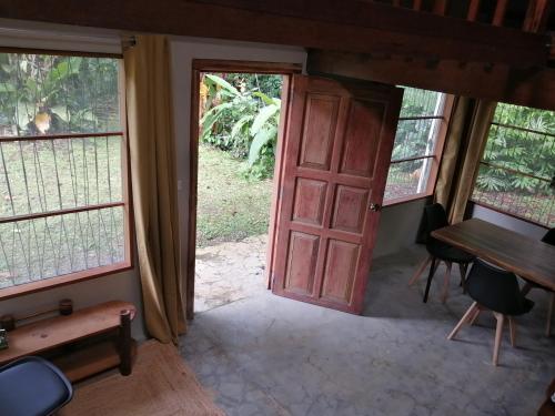 a door to a room with a desk and a table at Casa of Dreams in Dos Brazos