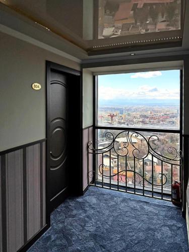 an open door to a balcony with a view at New Nairi Hotel Yerevan in Yerevan
