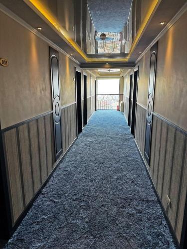 a hallway in a building with a long corridor at New Nairi Hotel Yerevan in Yerevan