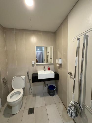 a bathroom with a toilet and a sink at Eclipse Residence in Cyberjaya