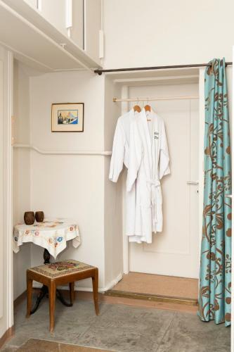 a white coat hanging on a wall in a room at Maison DuBois in Le Locle