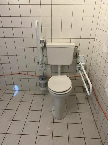 a bathroom with a white toilet in a stall at Hotel De Elderschans in Aardenburg