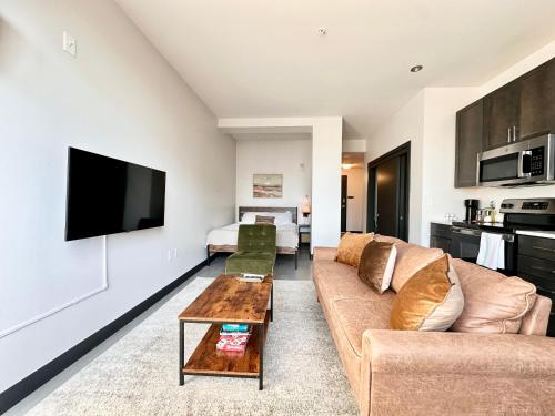 a living room with a couch and a table at Deer District Studio Apt - One Block from Fiserv and Baird in Milwaukee