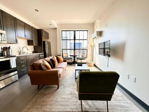 a living room with a couch and a table at Deer District Studio Apt - One Block from Fiserv and Baird in Milwaukee