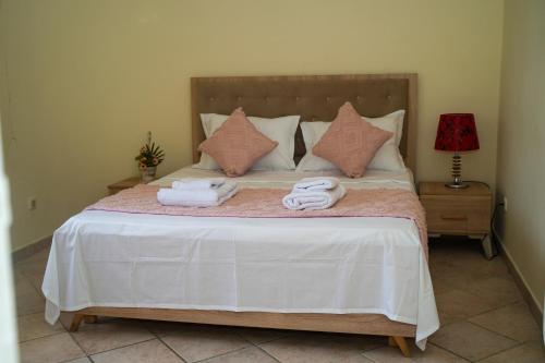 a bedroom with a bed with towels on it at Les villas Africa Jade in Korba