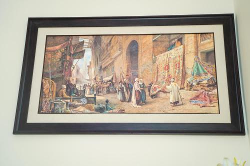 a framed picture of a painting on a wall at Les villas Africa Jade in Korba