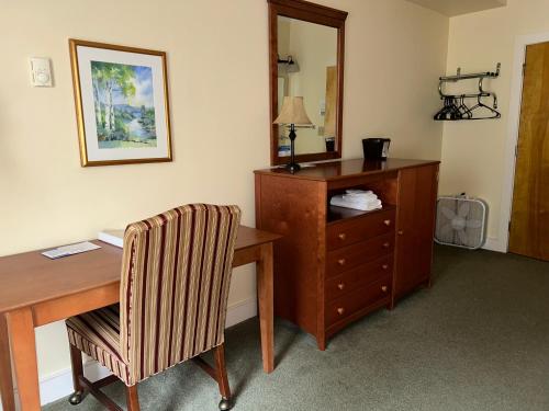 a room with a desk and a chair and a dresser at Silver Bay YMCA Inn and Conference Center in Silver Bay