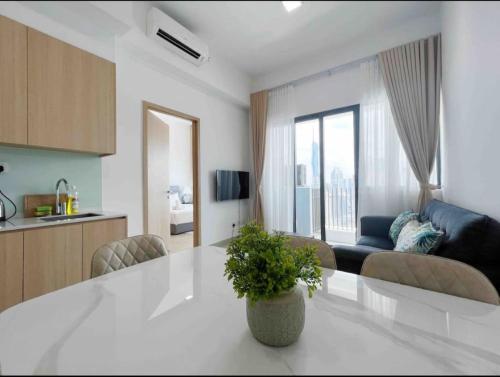 a kitchen and living room with a table and a couch at The Luxe & Colony Infinitum KLCC by CoupleStay in Kuala Lumpur
