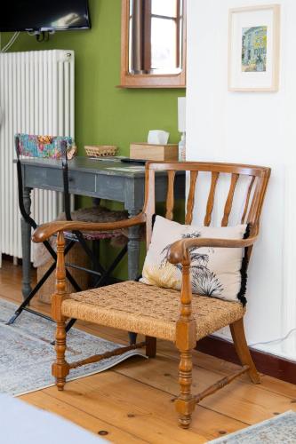 a wooden chair sitting in front of a desk at Maison DuBois in Le Locle